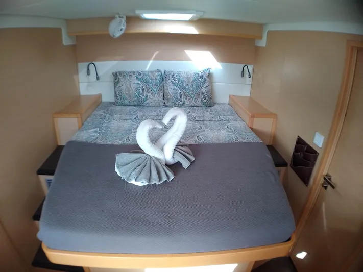 Nauti By Nature II Yacht Photos Pics Luxurious cabin interior of 2017 Lagoon 52 yacht with elegant bedding and towel swans.