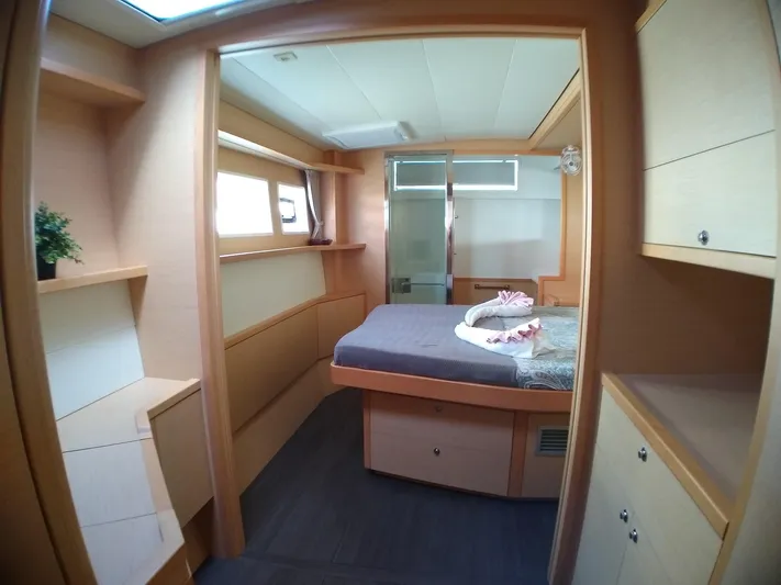 Nauti By Nature II Yacht Photos Pics 2017 Lagoon 52 yacht cabin with modern design, featuring a cozy bed and ample storage.