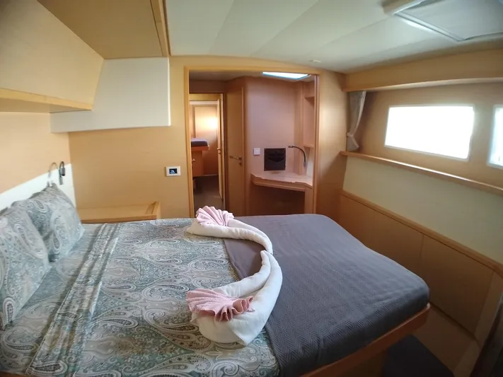 Nauti By Nature II Yacht Photos Pics Luxurious bedroom interior of 2017 Lagoon 52 yacht with elegant bedding and natural light.