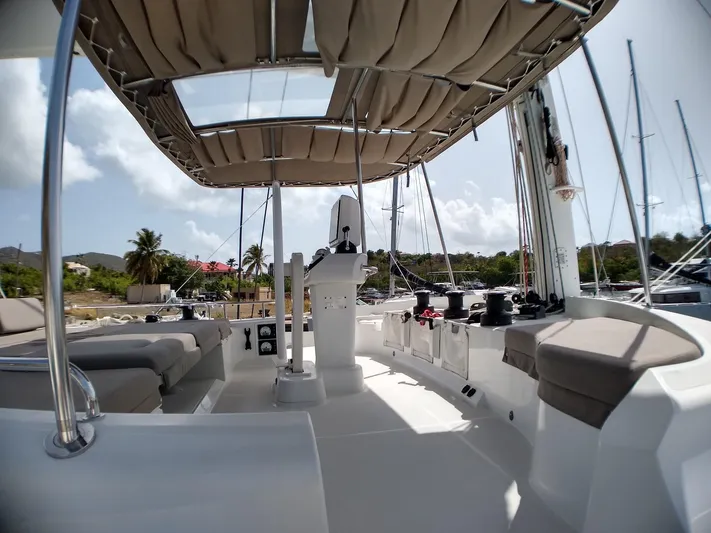Nauti By Nature II Yacht Photos Pics 2017 Lagoon 52 yacht deck with seating, helm, and canopy under clear skies.