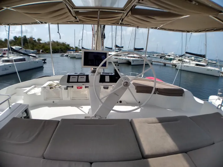 Nauti By Nature II Yacht Photos Pics Helm of 2017 Lagoon 52 catamaran with marina view.
