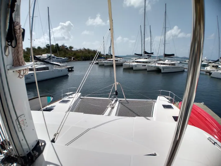 Nauti By Nature II Yacht Photos Pics 2017 Lagoon 52 catamaran docked in a marina with other sailboats.