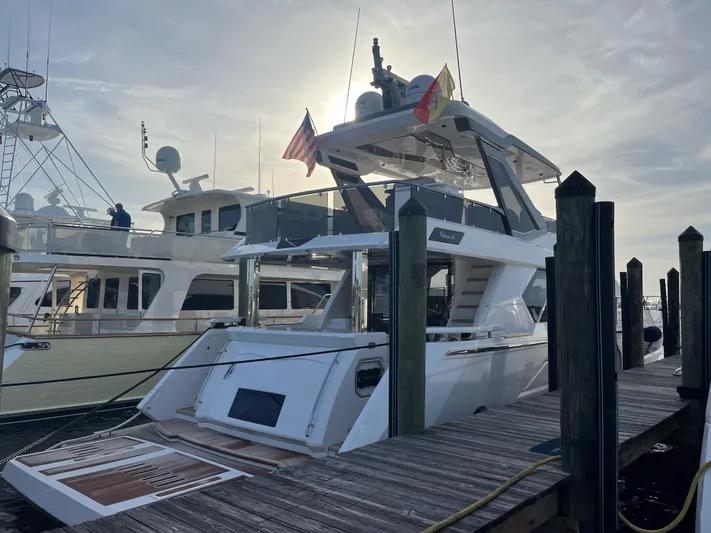 4 Stateroom Layout Yacht Photos Pics 2024 Aicon 66 Vivere yacht docked at marina under a cloudy sky.