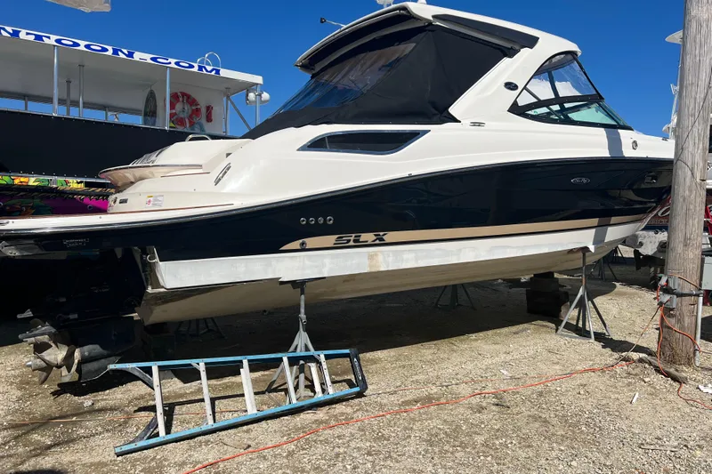  Yacht Photos Pics 2015 Sea Ray 350 SLX boat on stands, displayed outdoors under clear blue sky.