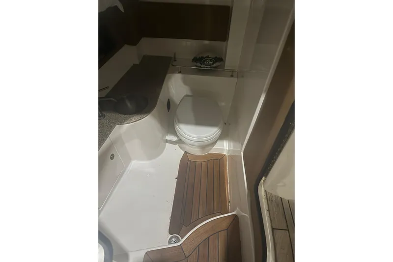  Yacht Photos Pics 2015 Sea Ray 350 SLX boat bathroom with wooden flooring and compact design.