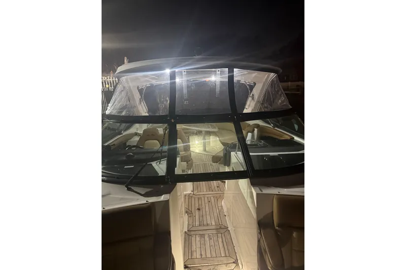  Yacht Photos Pics 2015 Sea Ray 350 SLX boat interior at night, featuring illuminated seating and dashboard.