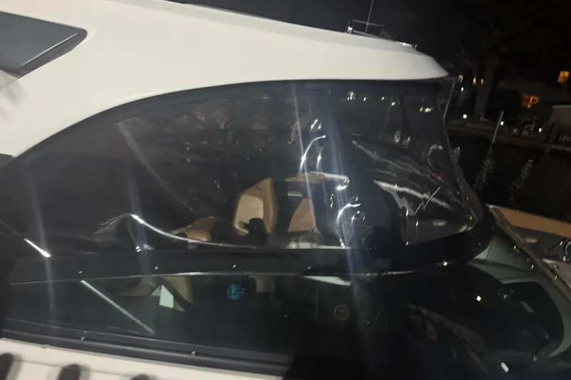  Yacht Photos Pics 2015 Sea Ray 350 SLX boat with clear canopy at night, docked by the water.