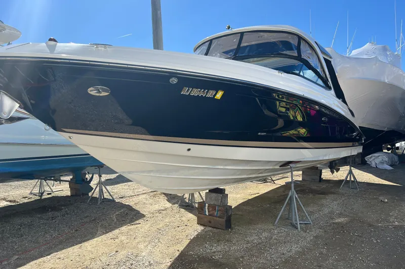  Yacht Photos Pics 2015 Sea Ray 350 SLX boat on stands, blue and white hull, sunny day.