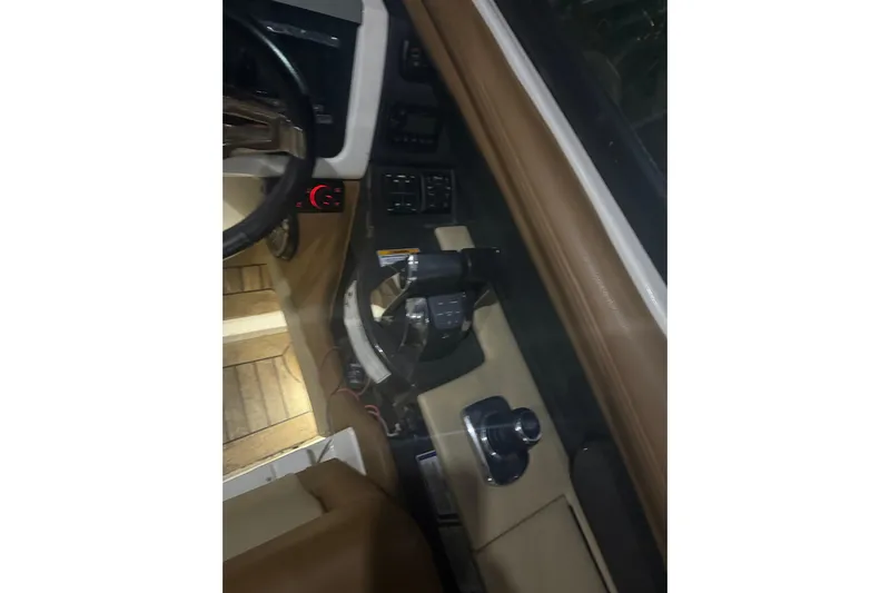  Yacht Photos Pics Interior view of 2015 Sea Ray 350 SLX boat cockpit with controls and steering wheel.