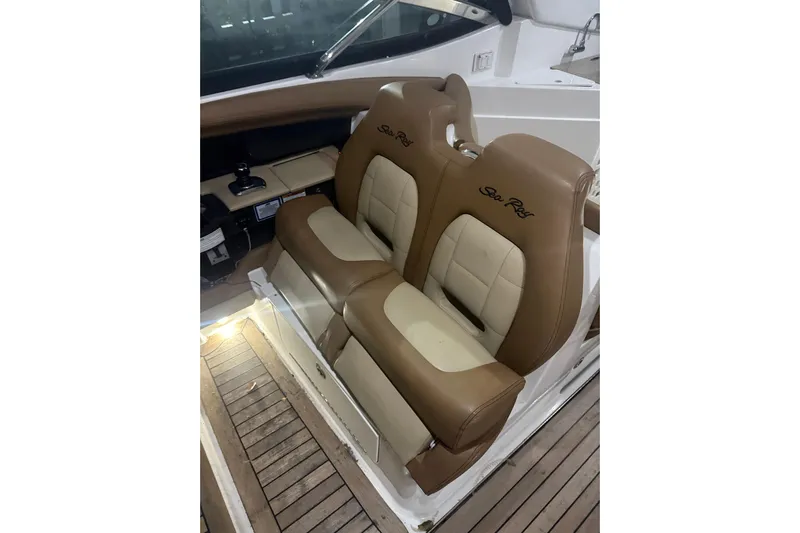  Yacht Photos Pics 2015 Sea Ray 350 SLX boat interior with tan leather seats and wooden flooring.