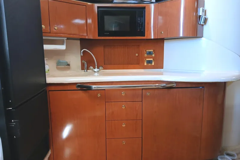 Seaswing Yacht Photos Pics 2002 Sea Ray 380 Sundancer yacht kitchen with wood cabinetry and modern appliances.