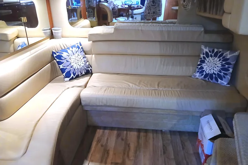 Seaswing Yacht Photos Pics Luxurious interior of 2002 Sea Ray 380 Sundancer with beige seating and decorative pillows.