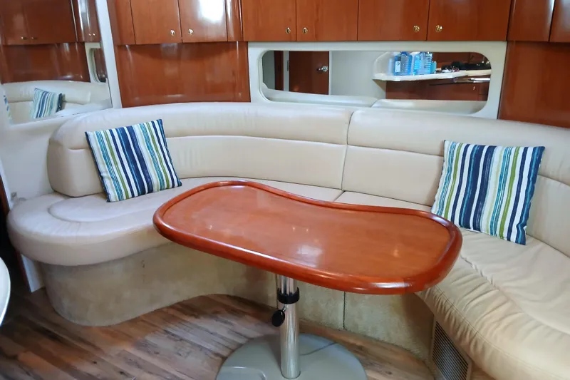 Seaswing Yacht Photos Pics Luxurious interior of 2002 Sea Ray 380 Sundancer with curved seating and striped cushions.