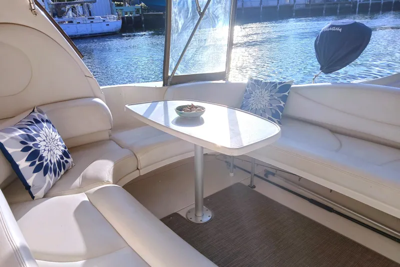 Seaswing Yacht Photos Pics Luxurious seating area on a 2002 Sea Ray 380 Sundancer yacht with waterfront view.
