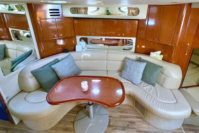 Seaswing Yacht Photos Pics Luxurious 2002 Sea Ray 380 Sundancer yacht interior with leather seating and wooden table.