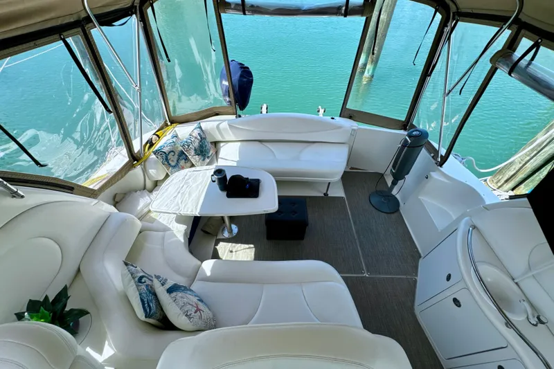 Seaswing Yacht Photos Pics Interior of 2002 Sea Ray 380 Sundancer yacht with white seating and table.
