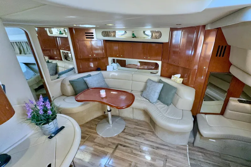 Seaswing Yacht Photos Pics Luxurious interior of a 2002 Sea Ray 380 Sundancer yacht with plush seating and wooden accents.