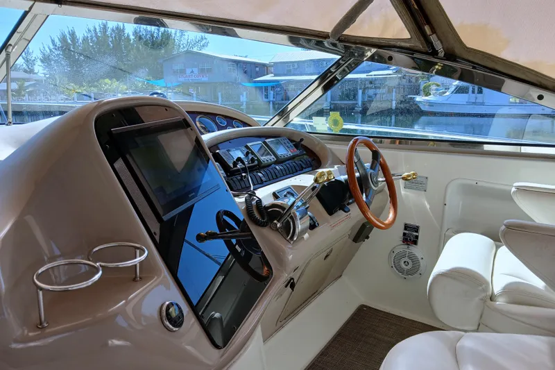 Seaswing Yacht Photos Pics 2002 Sea Ray 380 Sundancer helm with modern controls and luxurious seating.