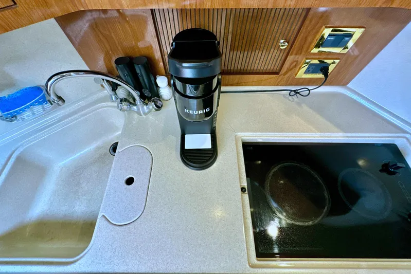 Seaswing Yacht Photos Pics Kitchenette in 2002 Sea Ray 380 Sundancer with sink, Keurig coffee maker, and stove.