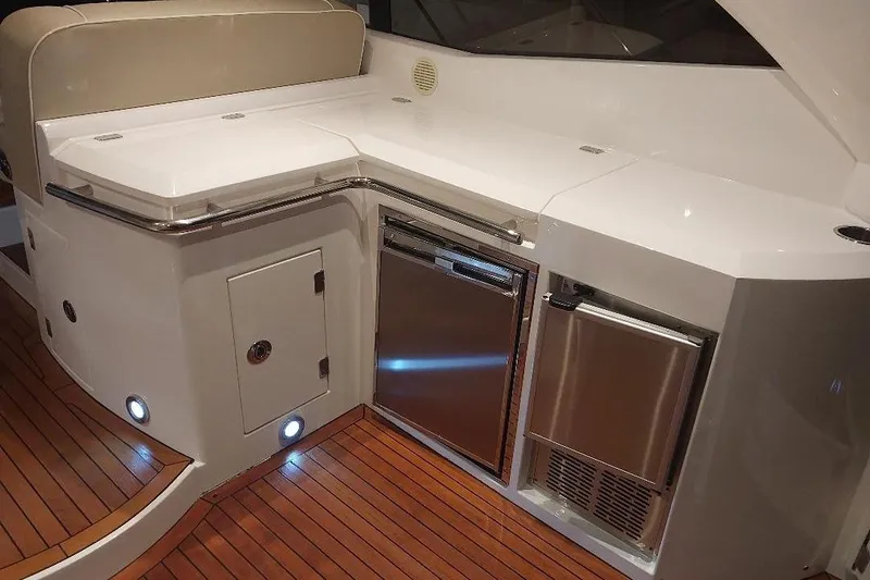 Albacore Yacht Photos Pics Luxurious 2012 Sunseeker Portofino 48 yacht interior with sleek kitchenette and wooden flooring.