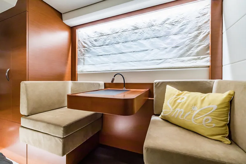  Yacht Photos Pics Luxurious interior of 2013 Prestige 500 Fly yacht with cozy seating and "Smile" pillow.