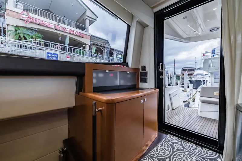  Yacht Photos Pics Interior view of 2013 Prestige 500 Fly yacht with marina and restaurant in background.