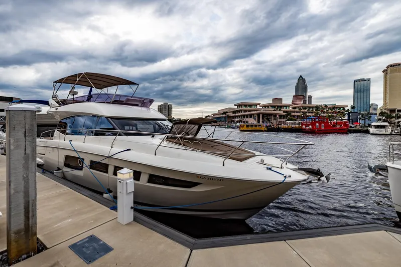  Yacht Photos Pics Prestige 500 Fly 2013 yacht docked at marina with city skyline backdrop.