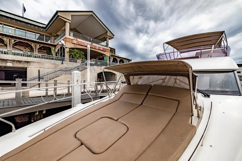  Yacht Photos Pics Prestige 500 Fly 2013 yacht docked near a waterfront building under cloudy skies.