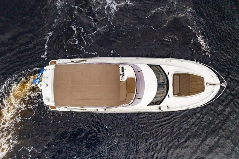  Yacht Photos Pics Aerial view of 2013 Prestige 500 Fly yacht cruising on dark water.