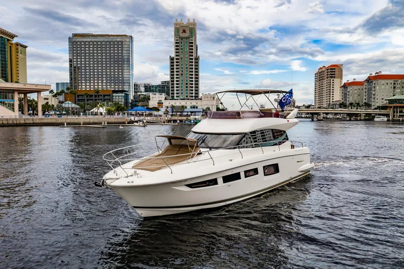  Yacht Photos Pics 2013 Prestige 500 Fly yacht cruising in urban waterfront setting with city skyline.