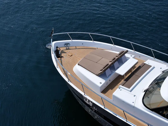 Sea At Last Yacht Photos Pics Luxurious 2025 Altima Express Coupe yacht with spacious sun deck on calm blue waters.