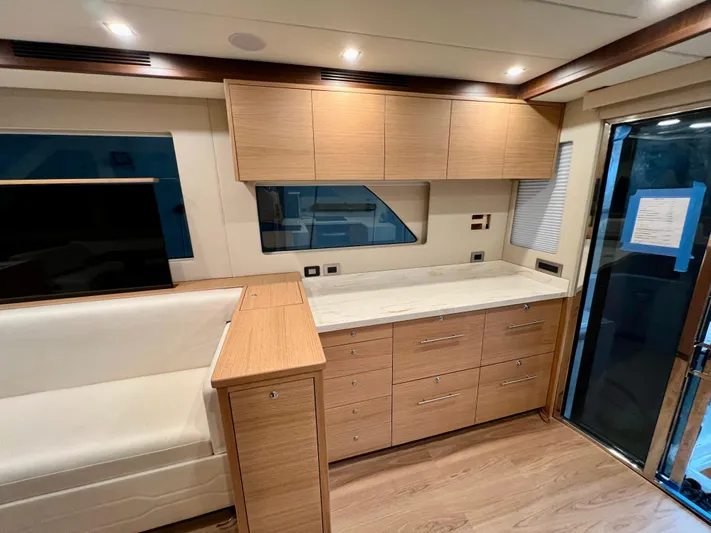 Sea At Last Yacht Photos Pics Modern interior of 2025 Altima Express Coupe with wood cabinetry and sleek design.