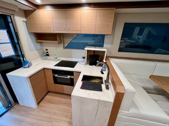 Sea At Last Yacht Photos Pics Modern kitchen interior in 2025 Altima Express Coupe yacht, featuring sleek cabinetry and appliances.