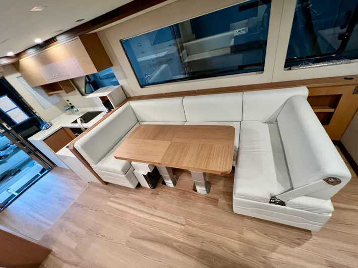 Sea At Last Yacht Photos Pics Luxurious interior of 2025 Altima Express Coupe with modern seating and dining area.