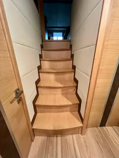 Sea At Last Yacht Photos Pics Wooden staircase inside 2025 Altima Express Coupe, featuring modern design and sleek paneling.