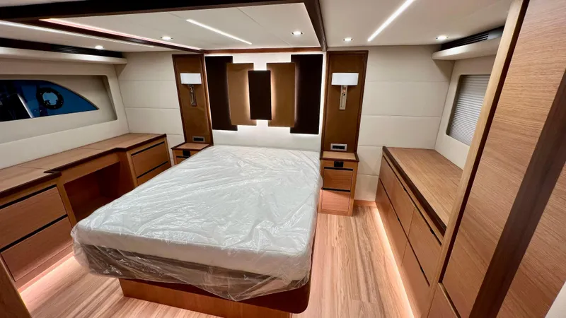 Sea At Last Yacht Photos Pics Luxurious 2025 Altima Express Coupe bedroom with modern wood furnishings and ambient lighting.