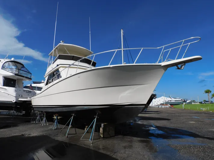 Miss Approach Yacht Photos Pics 1991 Viking 45' Convertible yacht on dry dock under clear blue sky.