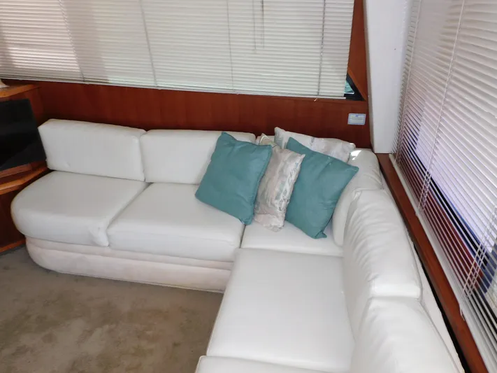 Miss Approach Yacht Photos Pics Luxurious white leather seating with teal pillows in 1991 Viking 45' Convertible yacht.