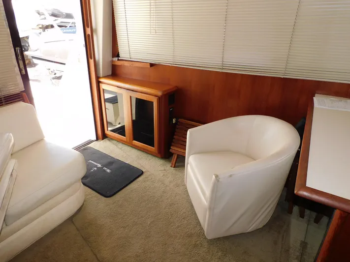 Miss Approach Yacht Photos Pics Interior of 1991 Viking 45' Convertible yacht with white seating and wooden cabinetry.