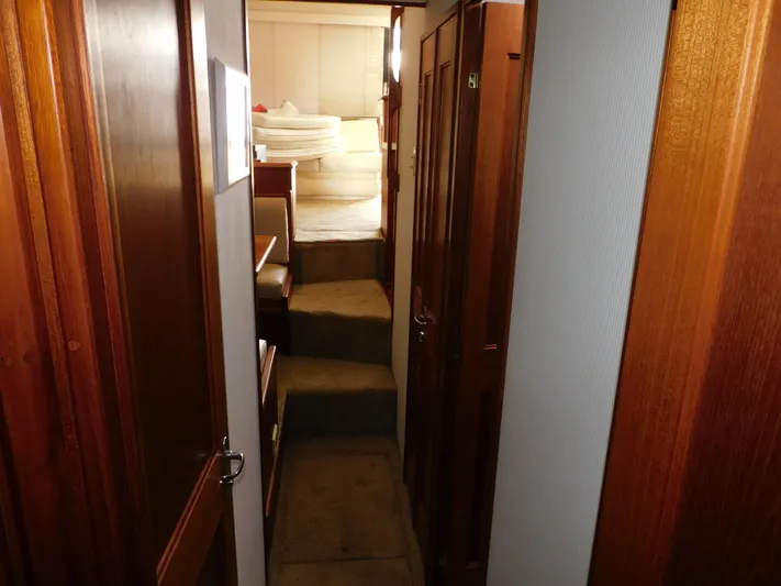Miss Approach Yacht Photos Pics Interior hallway of 1991 Viking 45' Convertible yacht with wooden doors and carpeted steps.