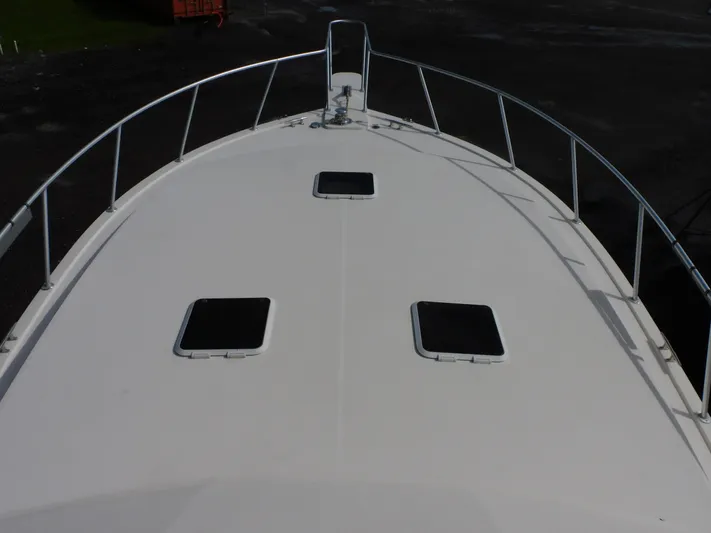 Miss Approach Yacht Photos Pics 1991 Viking 45' Convertible boat deck with hatches and railing.