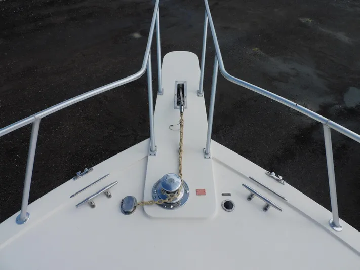 Miss Approach Yacht Photos Pics Bow of 1991 Viking 45' Convertible yacht with anchor chain and railing.