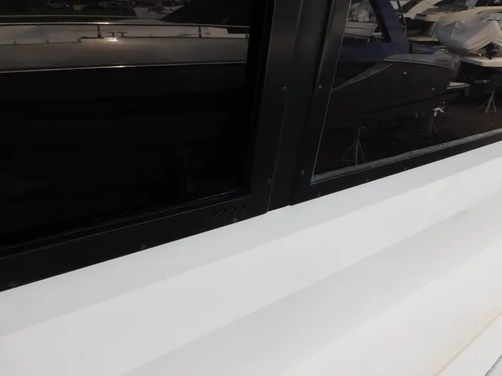 Miss Approach Yacht Photos Pics Close-up of 1991 Viking 45' Convertible boat window and hull.