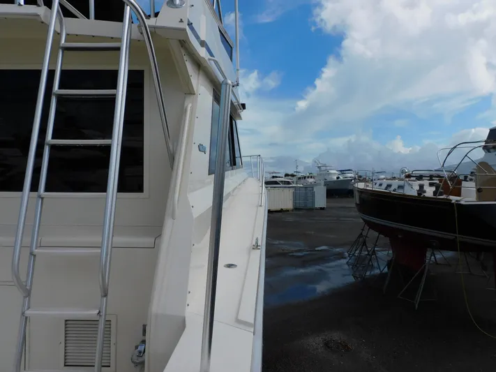 Miss Approach Yacht Photos Pics 1991 Viking 45' Convertible yacht in a marina with cloudy sky.