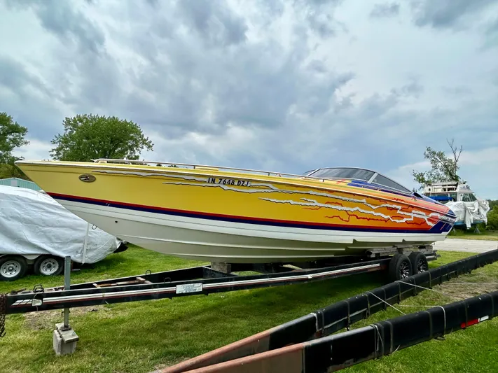  Yacht Photos Pics 2008 Formula 353 FASTech speedboat with vibrant graphics on a trailer, under cloudy skies.