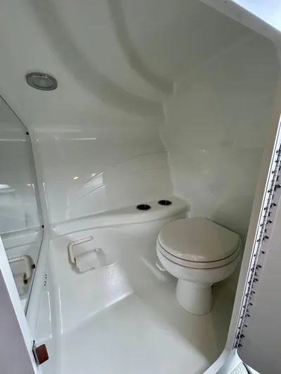  Yacht Photos Pics 2008 Formula 353 FASTech boat bathroom with white interior and compact toilet.