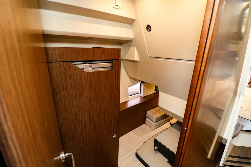  Yacht Photos Pics 2021 Jeanneau NC 1095 interior cabin with wooden cabinetry and modern design.