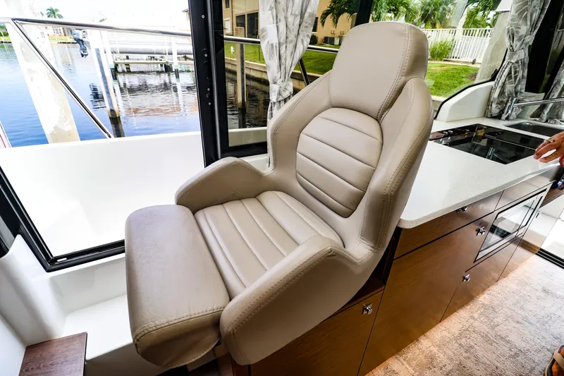  Yacht Photos Pics Luxurious interior seating on 2021 Jeanneau NC 1095 boat, featuring plush leather chair.