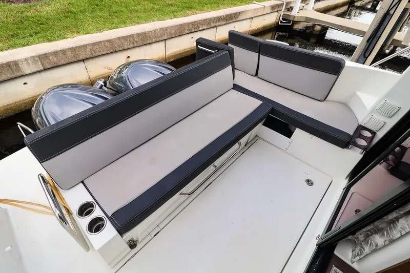  Yacht Photos Pics 2021 Jeanneau NC 1095 boat with cushioned seating and dual outboard motors.