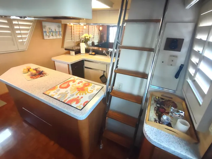  Yacht Photos Pics Interior of 1988 Hatteras 60 Motor Yacht kitchen with modern amenities and wooden accents.